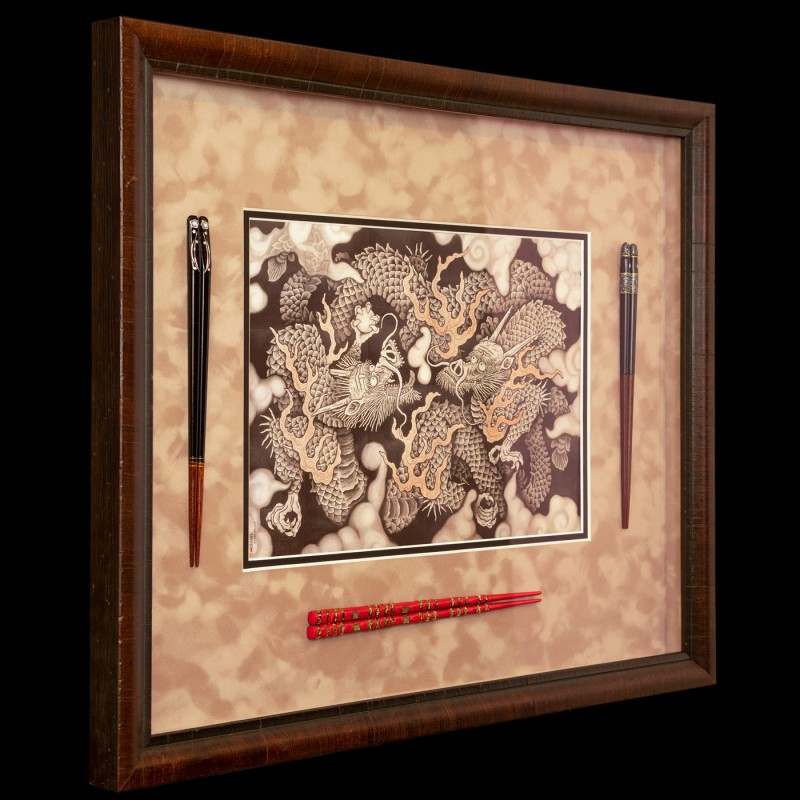 Detail of Japanese print and chopsticks in picture frame.