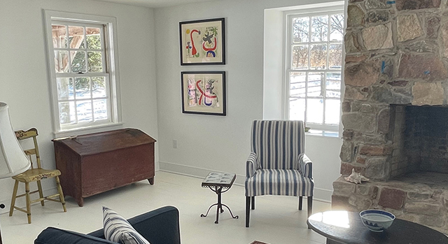 Art hung on gray walls. 